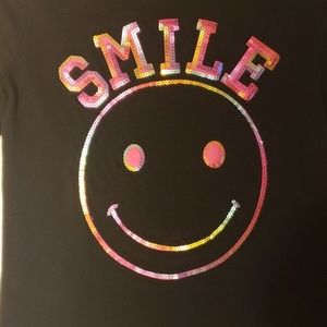 Black tee with iridescent sequin smiley face